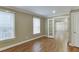 Bedroom featuring neutral paint, hardwood flooring, and two large windows at 2118 Town Manor Ct, Dacula, GA 30019
