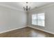 Bedroom featuring hardwood floors, large window, wainscotting, and chandelier at 2118 Town Manor Ct, Dacula, GA 30019