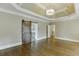 Bedroom featuring hardwood floors and a rustic barn door leading to the ensuite bathroom, offering privacy and style at 2118 Town Manor Ct, Dacula, GA 30019