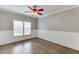 Bedroom featuring stylish hardwood flooring, large window, ceiling fan, and neutral paint at 2118 Town Manor Ct, Dacula, GA 30019