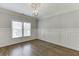 Bedroom featuring hardwood floors, wainscotting, window, and chandelier at 2118 Town Manor Ct, Dacula, GA 30019