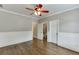 Bedroom featuring hardwood floors, large window, ceiling fan, and ensuite bathroom at 2118 Town Manor Ct, Dacula, GA 30019
