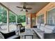 Covered patio with comfortable seating, ceiling fan, brick accents, and beautiful stone tile flooring at 2118 Town Manor Ct, Dacula, GA 30019