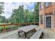 Spacious wooden deck featuring a large outdoor dining table with bench seating and backyard views at 2118 Town Manor Ct, Dacula, GA 30019