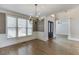 Well-lit dining room featuring hardwood floors, wainscoting, and windows, offering an open floor plan at 2118 Town Manor Ct, Dacula, GA 30019