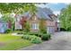 Spacious brick house with an attached three-car garage and a meticulously landscaped front yard at 2118 Town Manor Ct, Dacula, GA 30019