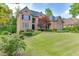 Charming brick home with a well-maintained lawn, lovely landscaping, and a welcoming facade at 2118 Town Manor Ct, Dacula, GA 30019