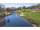 Scenic golf course view with a pond and sand traps surrounded by lush greenery at 2118 Town Manor Ct, Dacula, GA 30019