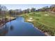 Scenic golf course view featuring a pond, sand traps, and lush green fairways at 2118 Town Manor Ct, Dacula, GA 30019