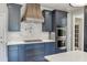 Well-appointed kitchen features a stainless steel range hood, pot filler, and built-in double ovens at 2118 Town Manor Ct, Dacula, GA 30019