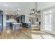 Open concept kitchen features a central island, modern appliances, and seamless flow to the living space at 2118 Town Manor Ct, Dacula, GA 30019