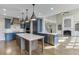 A very modern open kitchen with an island that can accommodate seating and an entrance to the living room at 2118 Town Manor Ct, Dacula, GA 30019