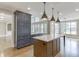 Kitchen view with an island that is directly adjacent to a spacious window-filled living room at 2118 Town Manor Ct, Dacula, GA 30019