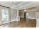 Bright living room showcasing hardwood floors and elegant columns that frame a door and a bedroom at 2118 Town Manor Ct, Dacula, GA 30019