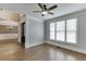 Inviting living room with hardwood floors, crown molding, and a large window showcasing natural light at 2118 Town Manor Ct, Dacula, GA 30019