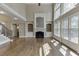 Open living room with hardwood floors, fireplace, and large windows at 2118 Town Manor Ct, Dacula, GA 30019