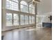 A spacious living room that has large windows, and a view of the kitchen at 2118 Town Manor Ct, Dacula, GA 30019