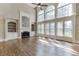 Bright living room with hardwood floors, fireplace, and large windows letting in natural light at 2118 Town Manor Ct, Dacula, GA 30019