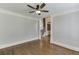 Spacious room with hardwood floors and crown molding showcasing an open floor plan with an adjacent staircase at 2118 Town Manor Ct, Dacula, GA 30019