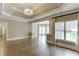 Spacious living room with tray ceilings, hardwood floors, and large windows that flood the space with natural light at 2118 Town Manor Ct, Dacula, GA 30019