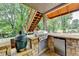 Outdoor kitchen equipped with a built-in grill, mini fridge, and Big Green Egg smoker near the deck stairs at 2118 Town Manor Ct, Dacula, GA 30019