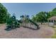 Community playground with green play structures, slides, and ample space for children to play at 2118 Town Manor Ct, Dacula, GA 30019