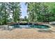 Beautiful backyard pool with stone surround and landscaping, perfect for entertaining or relaxing at 2118 Town Manor Ct, Dacula, GA 30019