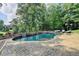 Gorgeous in-ground pool with waterfall features and brick patio area for outdoor enjoyment at 2118 Town Manor Ct, Dacula, GA 30019