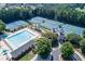 A beautiful pool and poolhouse are surrounded by plenty of seating, trees, and tennis courts at 2118 Town Manor Ct, Dacula, GA 30019
