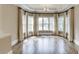 Bright sun room with hardwood floors, large windows, and elegant curtains, creating a warm and inviting space at 2118 Town Manor Ct, Dacula, GA 30019