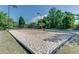 Sandy volleyball court ready for a fun game, with lighting for evening play at 2118 Town Manor Ct, Dacula, GA 30019