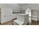 Large walk-in closet featuring built-in shelving, a central island with storage, and hardwood floors at 2118 Town Manor Ct, Dacula, GA 30019