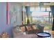 Comfortable living room with a large window, balcony, modern furniture, and vibrant artwork at 250 Park Avenue West # 802, Atlanta, GA 30313