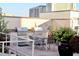 Outdoor kitchen and dining area with stainless steel grills and stylish patio furniture at 250 Park Avenue West # 802, Atlanta, GA 30313