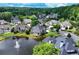 Aerial view of brick home and landscaped backyard and waterways in a planned community at 9325 Saint Georgen Cmn, Duluth, GA 30097