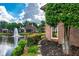 Brick home with lush landscaping and a beautiful pond with a fountain at 9325 Saint Georgen Cmn, Duluth, GA 30097