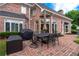 Backyard featuring a red brick patio and outdoor dining area at 9325 Saint Georgen Cmn, Duluth, GA 30097