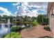 Brick patio by the pond with beautiful landscaping and a fountain in the distance at 9325 Saint Georgen Cmn, Duluth, GA 30097