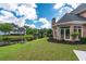 Brick home with a bay window overlooking a pond with lush landscaping at 9325 Saint Georgen Cmn, Duluth, GA 30097