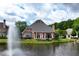 Brick home with a patio overlooking the waterway with a fountain at 9325 Saint Georgen Cmn, Duluth, GA 30097