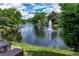Brick patio with an outdoor dining set, overlooking a pond with a fountain at 9325 Saint Georgen Cmn, Duluth, GA 30097