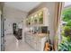 Stylish bar area with granite countertops, glass-front cabinets, and a window offering views of the yard at 9325 Saint Georgen Cmn, Duluth, GA 30097