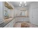 Bathroom featuring double sinks, granite countertops, white cabinets, chandelier, and herringbone flooring at 9325 Saint Georgen Cmn, Duluth, GA 30097