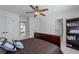 Bedroom featuring neutral colors, a ceiling fan, and an open doorway to another room at 9325 Saint Georgen Cmn, Duluth, GA 30097