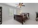 Bedroom featuring a ceiling fan, window with plantation shutters, and neutral carpeting at 9325 Saint Georgen Cmn, Duluth, GA 30097