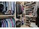 Walk-in closet with built-in shelving and hanging racks to maximize storage and organization at 9325 Saint Georgen Cmn, Duluth, GA 30097