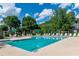 Relaxing community pool area with lounge chairs, tables and umbrellas for residents' enjoyment at 9325 Saint Georgen Cmn, Duluth, GA 30097