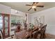 Formal dining area leading to living spaces, featuring a large table, china cabinet, and elegant decor at 9325 Saint Georgen Cmn, Duluth, GA 30097