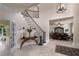 Elegant foyer with curved staircase, detailed ironwork, console table, and open access to the dining area at 9325 Saint Georgen Cmn, Duluth, GA 30097
