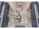 Grand foyer featuring a curved staircase, soaring ceilings, and elegant tile flooring with an ornate entry at 9325 Saint Georgen Cmn, Duluth, GA 30097